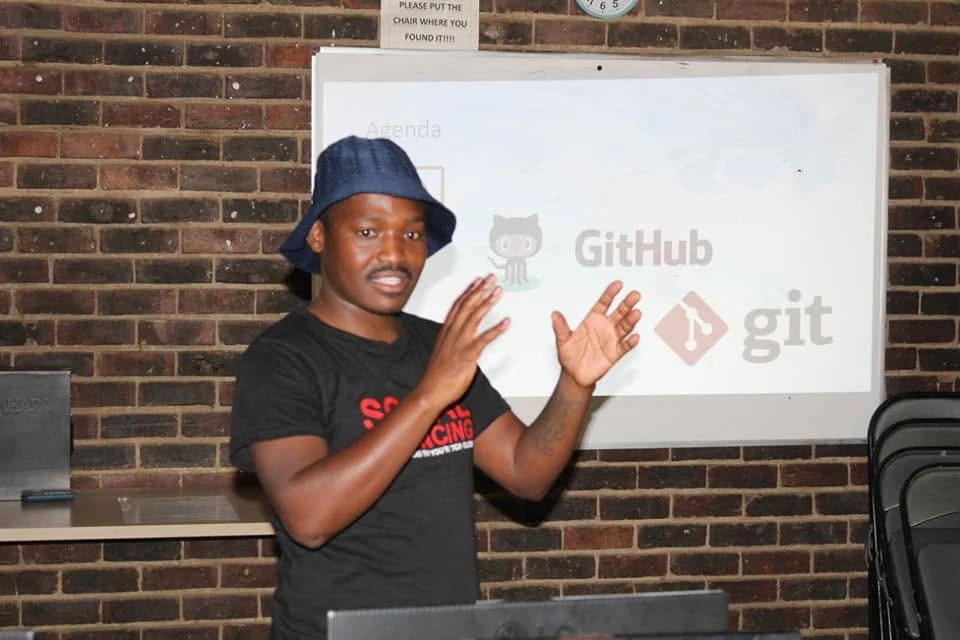 Thabiso Naleli presenting a session on GitHub and git in front of a whiteboard